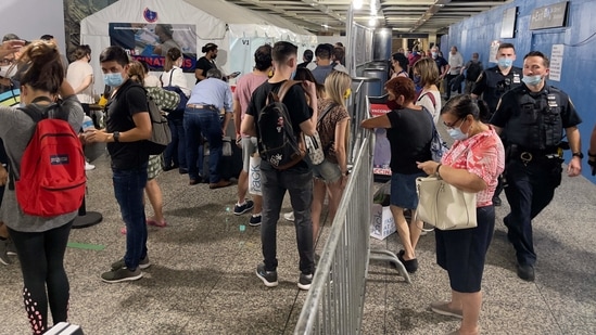 People line up to get a free Johnson & Johnson Covid-19 vaccine for everyone over 18, including tourists, at Penn Station, in New York city.(AFP) People line up to get a free Johnson & Johnson Covid-19 vaccine for everyone over 18, including tourists, at Penn Station, in New York city.(AFP)