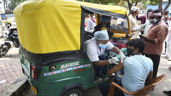 Health workers administer Covid-19 vaccine doses to auto-rickshaw drivers outside the railway station in Ranchi. (PTI Photo) Health workers administer Covid-19 vaccine doses to auto-rickshaw drivers outside the railway station in Ranchi. (PTI Photo)