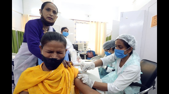 A medic inoculates the dose of COVID-19 vaccine to a woman during a 'Women Special' vaccination drive, at Avanti Bai Mahila Chikitsalaya in Lucknow. (ANI file)