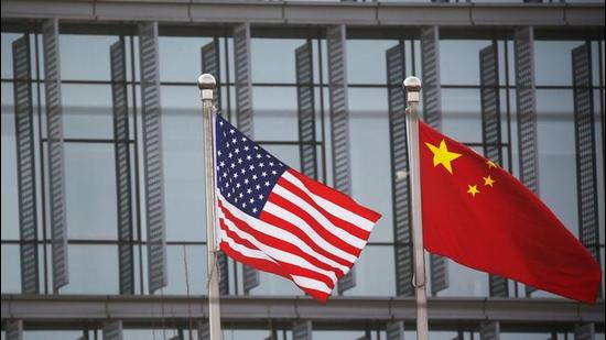 Chinese and US flags flutter outside the building of an American company in Beijing, China. (REUTERS) Chinese and US flags flutter outside the building of an American company in Beijing, China. (REUTERS)