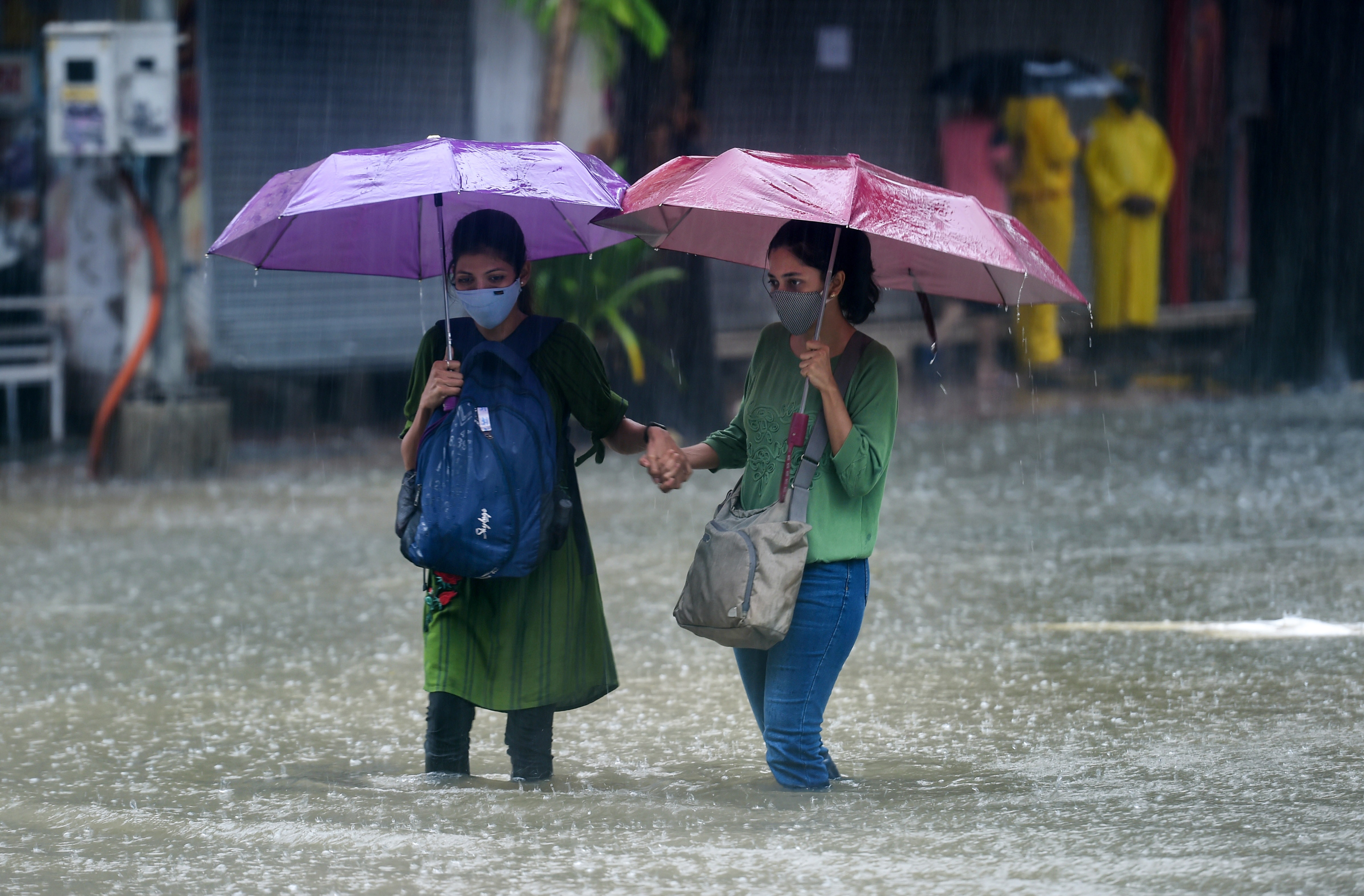 People wade through a waterlogged street at Hindmata in Mumbai, Wednesday, June 9, 2021. (PTI) People wade through a waterlogged street at Hindmata in Mumbai, Wednesday, June 9, 2021. (PTI)