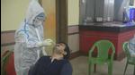 A Kolkata Municipal Corporation health staff member collects a swab sample from a man. (HT archive) A Kolkata Municipal Corporation health staff member collects a swab sample from a man. (HT archive)