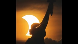 A glimpse of the Solar Eclipse capture behind the Statue of Liberty in USA.