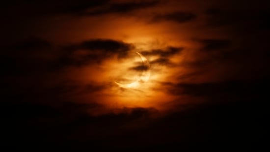 As the sun rises in the Berkshires, the moon passes between the earth and sun, casting its shadow over the earth's Northern Hemisphere for an annular solar eclipse on June 10.(Stephanie Zollshan/The Berkshire Eagle via AP)