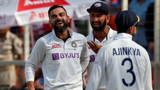 India's captain Virat Kohli celebrates with his teammates Cheteshwar Pujara and Ajinkya Rahane(REUTERS)