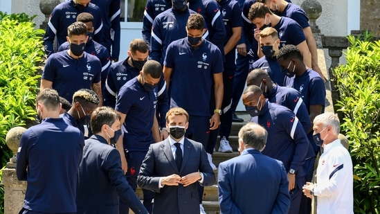 French President Emmanuel Macron poses for pictures with French players before a lunch.(REUTERS)