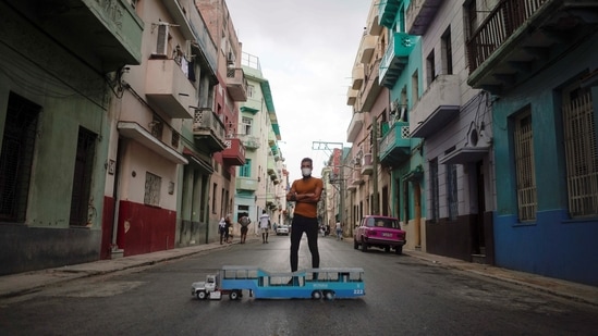 Aurelio Tabares poses for a photo next to his model truck in Havana, Cuba, May 20, 2021. Picture taken on May 20, 2021. (REUTERS)