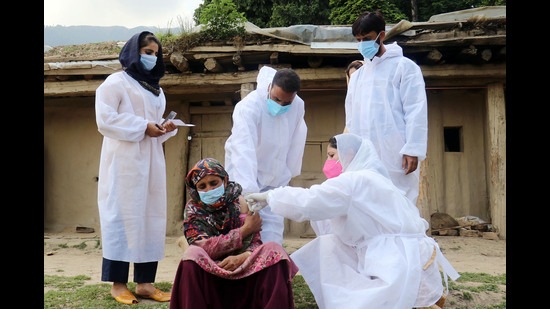 A medic injects a dose of Covid vaccine to a Gujjar woman at Doodhpathri in Budgam on Thursday. (ANI) A medic injects a dose of Covid vaccine to a Gujjar woman at Doodhpathri in Budgam on Thursday. (ANI)