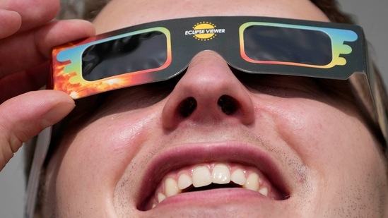 A man wears special glasses to watch the partial solar eclipse in Trafalgar Square, London, on June 10. The eclipse was expected to be partial, which means the people in its shadow weren't plunged into daytime darkness.(Frank Augstein / AP)