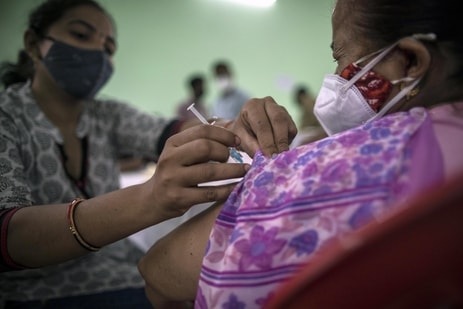 A person receives a Covid-19 vaccination at the KD Singh Babu stadium in Lucknow. (Bloomberg)