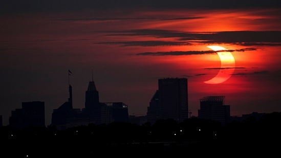 A partial solar eclipse rises over the Baltimore skyline, as seen from Arbutus, US, on June 10.(AP / PTI)