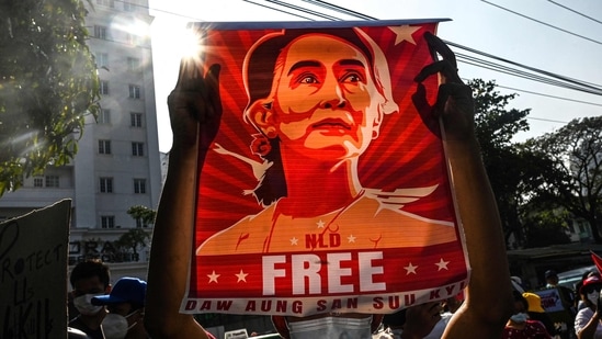 A protester holds up a poster featuring Aung San Suu Kyi during a demonstration against the military coup at in front of the Central Bank of Myanmar in Yangon.(AFP)