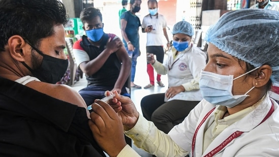 A healthcare worker administers the Covid-19 vaccine dose to a shopkeeper in Bhopal, on Tuesday.(File Photo / PTI)