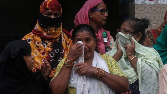 A woman wipes her tears after a three-story dilapidated building collapsed following heavy monsoon rains in Mumbai.(AP)