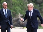 Britain's Prime Minister Boris Johnson speaks with US President Joe Biden while they walk with their wife Carrie Johnson (not seen) and US first lady Jill Biden (not seen), outside Carbis Bay Hotel, Carbis Bay, Cornwall, Britain on June 10, 2021. 
