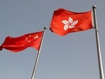 FILE PHOTO: The Chinese and Hong Kong flags flutter at the office of the Government of the Hong Kong Special Administrative Region. 
