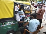 Health workers administer the Covid-19 vaccine to auto-rickshaw drivers outside the railway station in Ranchi, Jharkhand, on Tuesday. 