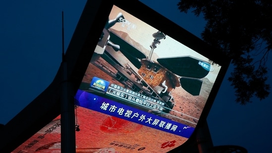 In one of the pictures the Chinese Zhurong rover and lander bearing the national flag can be seen on the surface of Mars. (REUTERS)