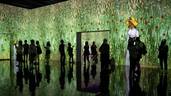 People attend a media preview of the "Immersive van Gogh" exhibit at Pier 36 on May 26, 2021 in New York City. - The art installation displays iconic works of post-Impressionist artist Vincent van Gogh, evoking his emotional and chaotic inner consciousness through art, light, music and movement. (AFP)
