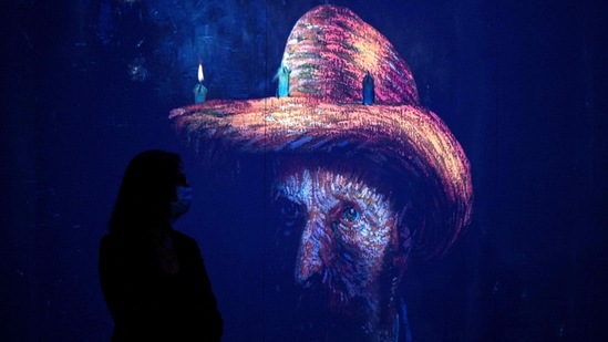 People attend a media preview of the "Immersive van Gogh" exhibit at Pier 36 on May 26, 2021 in New York City. - The art installation displays iconic works of post-Impressionist artist Vincent van Gogh, evoking his emotional and chaotic inner consciousness through art, light, music and movement.(AFP)