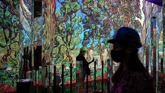People attend a media preview of the "Immersive van Gogh" exhibit at Pier 36 on May 26, 2021 in New York City. - (AFP)
