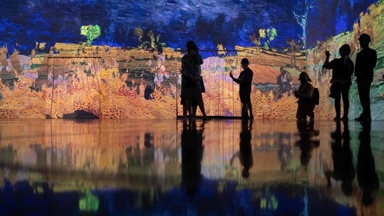 People attend a media preview of the "Immersive van Gogh" exhibit at Pier 36 on May 26, 2021 in New York City.(AFP)