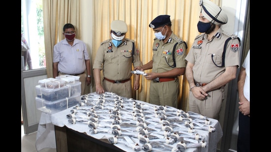 Police officials showing seized pistols in Amritsar on Friday. Sameer Sehgal /Hindustan Times Police officials showing seized pistols in Amritsar on Friday. Sameer Sehgal /Hindustan Times