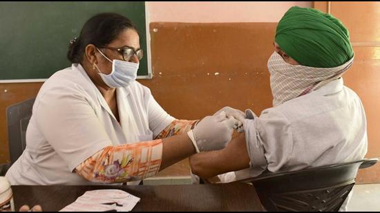A medic administers a Covid vaccine dose to a man in Ludhiana on Friday. (Harsimar Pal Singh/HT) A medic administers a Covid vaccine dose to a man in Ludhiana on Friday. (Harsimar Pal Singh/HT)