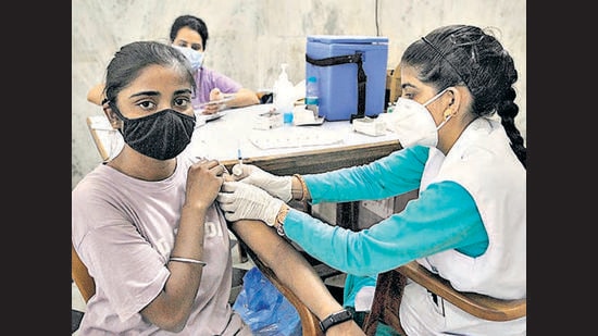 A young woman getting inoculated against Covid-19 at a camp organised by the Sector 21 market welfare association in Chandigarh on Friday. (Ravi Kumar/HT)