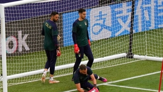 Italy goalie Gianluigi Donnarumma grabs the ball as goalkeepers Alex Meret and Salvatore Sirigu, left, look on, during a training session ahead of Friday's Euro 2020, group A match against Turkey.(AP)