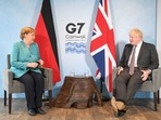 Britain's Prime Minister Boris Johnson and German Chancellor Angela Merkel attend a bilateral meeting during G7 summit in Carbis Bay, Cornwall, Britain.