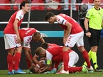 Denmark's Christian Eriksen receives medical attention after collapsing during the match.