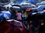 Crowd of people under the sea of umbrellas at Koparkhairane Market walk in rain in Navi Mumbai. 