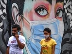 Pedestrians walk past a wall mural representing awareness measures against the Covid-19 coronavirus, in Navi Mumbai. Pedestrians walk past a wall mural representing awareness measures against the Covid-19 coronavirus, in Navi Mumbai.