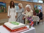 Britain's Queen Elizabeth II, centre, cuts a cake as Camilla, the Duchess of Cornwall, background centre and Kate, the Duchess of Cambridge stand by, as they attend an event in celebration of 'The Big Lunch 'initiative, during the G7 summit in Cornwall, England. Britain's Queen Elizabeth II, centre, cuts a cake as Camilla, the Duchess of Cornwall, background centre and Kate, the Duchess of Cambridge stand by, as they attend an event in celebration of 'The Big Lunch 'initiative, during the G7 summit in Cornwall, England.