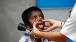 A healthcare worker examines a child during a door-to-door surveillance to safeguard children amidst the spread of the coronavirus disease (COVID-19), at a village on the outskirts of Ahmedabad. (REUTERS) A healthcare worker examines a child during a door-to-door surveillance to safeguard children amidst the spread of the coronavirus disease (COVID-19), at a village on the outskirts of Ahmedabad. (REUTERS)