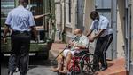 Mehul Choksi is taken to a police van in a wheelchair by a police officer after attending a court hearing, in Roseau, Dominica, earlier this week. (AP PHOTO.) Mehul Choksi is taken to a police van in a wheelchair by a police officer after attending a court hearing, in Roseau, Dominica, earlier this week. (AP PHOTO.)