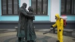 A Russian serviceman disinfects Moscow's Belorussky railway station next to a statue amid the Covid-19 pandemic.(AFP) A Russian serviceman disinfects Moscow's Belorussky railway station next to a statue amid the Covid-19 pandemic.(AFP)