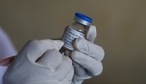 A health worker writes the date on a vial as she prepares to administer the COVAXIN coronavirus vaccine for people arriving to get their second dose at a public health center in Hyderabad. (AP Photo) A health worker writes the date on a vial as she prepares to administer the COVAXIN coronavirus vaccine for people arriving to get their second dose at a public health center in Hyderabad. (AP Photo)