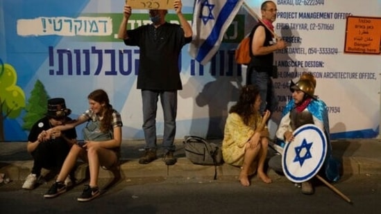 Protesters have condemned Netanyahu who became the first sitting Israeli prime minister indicted while in office, and is on trial for corruption. In picture - Protesters outside the PM's official residence in Jerusalem. (AP) Protesters have condemned Netanyahu who became the first sitting Israeli prime minister indicted while in office, and is on trial for corruption. In picture - Protesters outside the PM's official residence in Jerusalem. (AP)