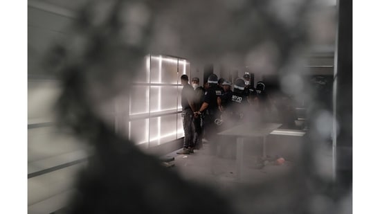 New York police officers arresting people inside a vandalized Balenciaga store in New York, on June 2, 2020, during street protests over the death of George Floyd.(Frank Franklin II / AP Photo)