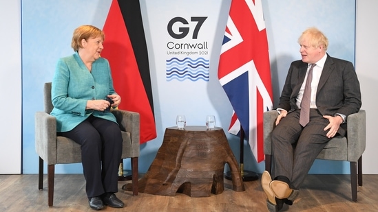 Britain's Prime Minister Boris Johnson and German Chancellor Angela Merkel attend a bilateral meeting during G7 summit in Carbis Bay, Cornwall, Britain. (REUTERS)