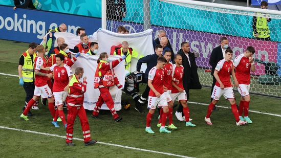  Denmark's Christian Eriksen is stretchered off the pitch after collapsing during the match as his teammates react.(REUTERS)