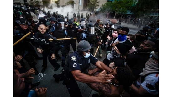 Police officers and protesters clash near CNN Center, May 29, 2020, in Atlanta, in response to George Floyd's death. The protest started peacefully earlier in the day before demonstrators clashed with police.(Mile Stewart / AP Photo)