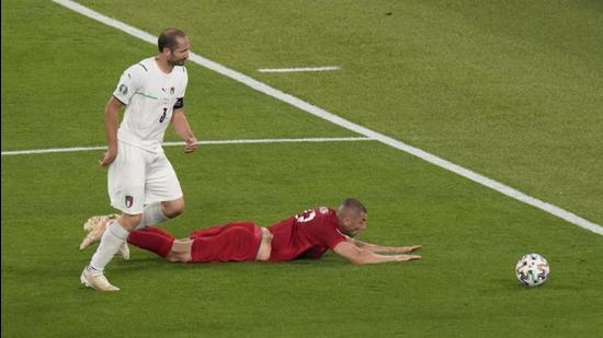 Turkey's Burak Yilmaz (on the ground) as Italy's Giorgio Chiellini goes for the ball during their Euro 2020 match. (Reuters)