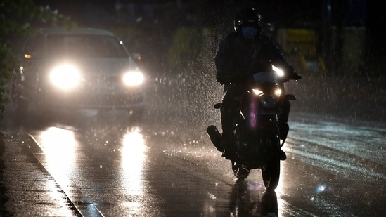  Commuters make their way during rain as Monsoon hits many parts of the city.(PTI file photo)