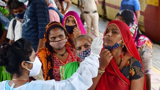 A medic collects nasal samples from a passenger at Dadar station to curb Covid-19 spread in Mumbai, on Friday, June 11, 2021. (PTI Photo)