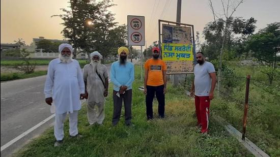 Residents of Sakraudi village in the district with a board that proclaims the village as drug free. (HT PHOTO)