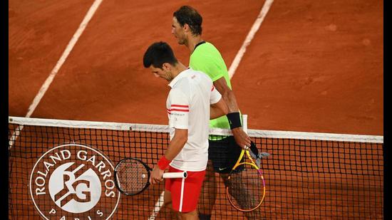 Serbia's Novak Djokovic (L) and Spain's Rafael Nadal shake hands at the end of their men's singles semi-final at the French Open. (AFP)