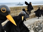 Climate change activists dressed up as black birds protest in St. Ives, on the sidelines of the G7 summit in Cornwall, England on June 11. The harbour town in southwest England is being used to host a media centre for reporters from around the world covering the first in-person gathering of the elite group since 2019.(Dylan Martinez / REUTERS)